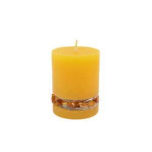 Candle with amber pieces around, yellow