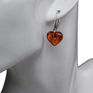 Heart shaped amber earrings with silver colored clasp