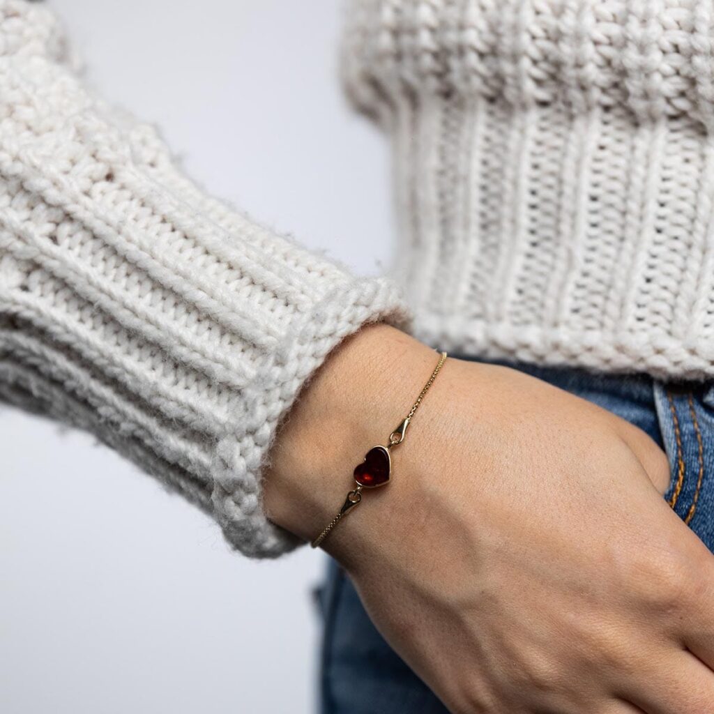 Silver bracelet with dark red amber heart, gold plated