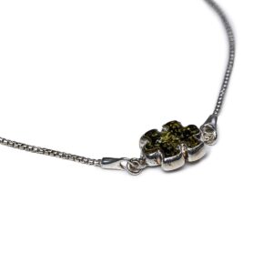 Silver bracelet with greenish amber puzzle piece