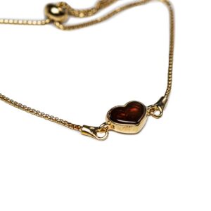 Silver bracelet with orange amber heart, gold plated