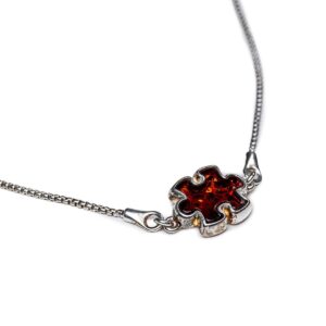 Silver bracelet with orange-red amber puzzle piece