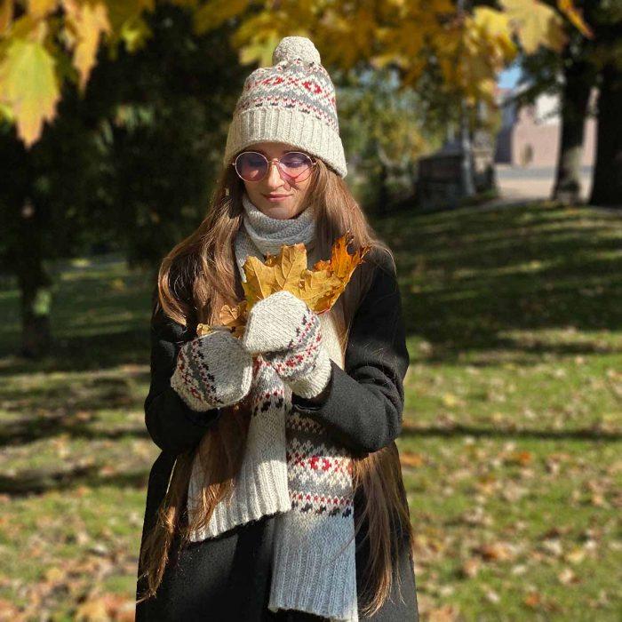 Knitted wool hat with pattern and pom pom, rollup edge, white