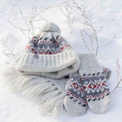 Knitted wool hat with pattern and pom pom, rollup edge, white