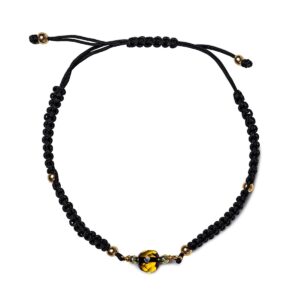 Bracelet with yellowgreen amber ball, black drawstring, ⌀ 5 cm