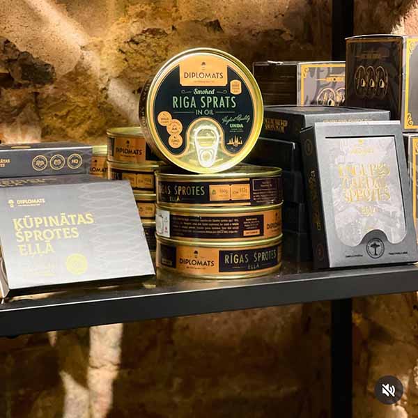 Gifts and souvenirs from baltic states Latvian smoked sprats and gourmet fish tins displayed in a historic Old Riga cellar shop